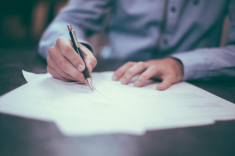 man-writing-on-paper.jpg